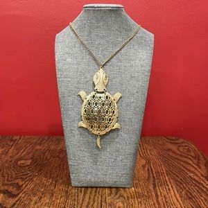 Gold tone turtle necklace